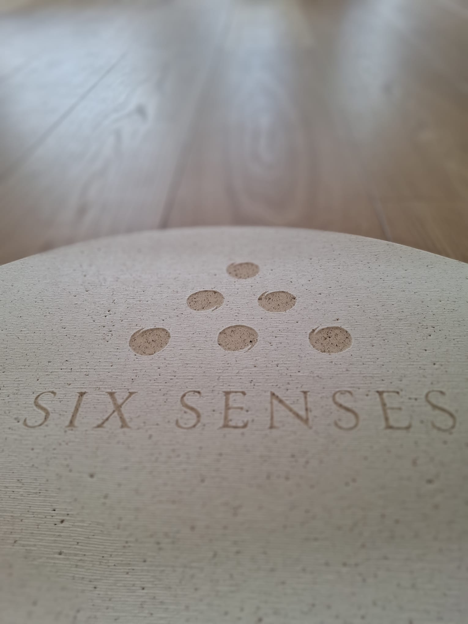 Six Senses logo embossed into a cork mat