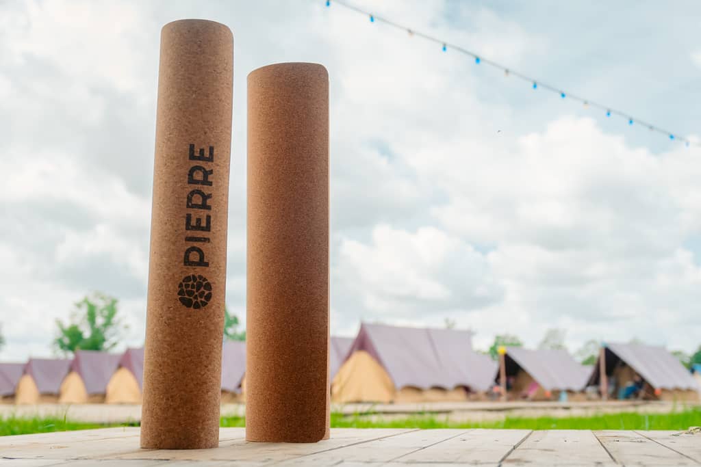 Rolled PIERRE cork mats stacked in a festival field