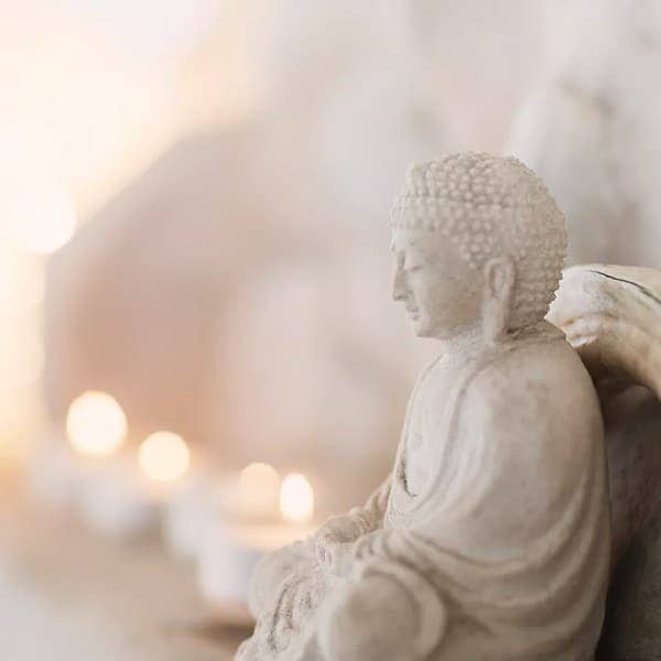 Stone Buddha Statue with Bokeh Candles