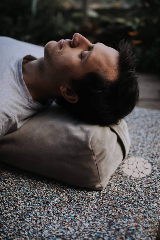 Man Resting on PIERRE Yoga Bolster