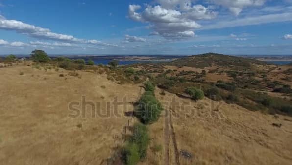 Dry Grass Hills With Distant Lake