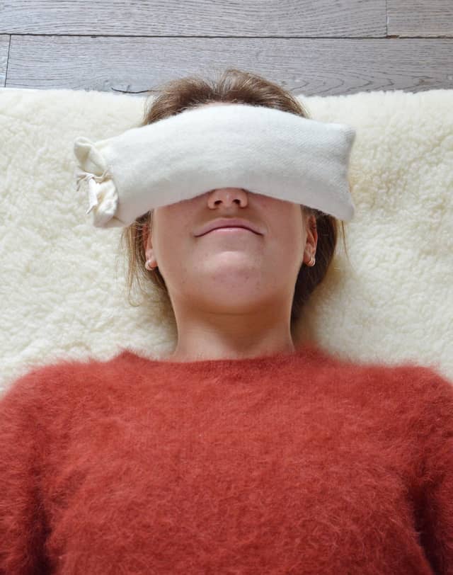 Woman Using PIERRE Wool Eye Pillow