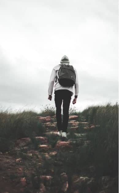 Hiker Walking Up A Rocky Path