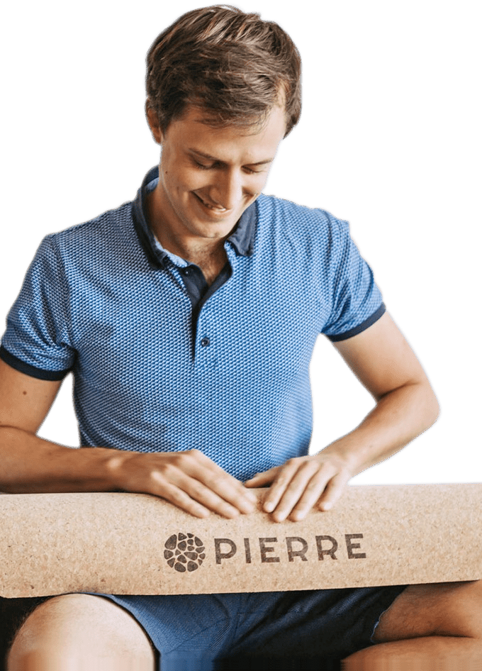 Pieter, founder of PIERRE, holding a cork yoga mat