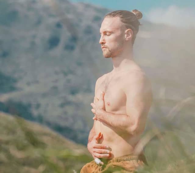 Man Meditating In Nature Near Mountains