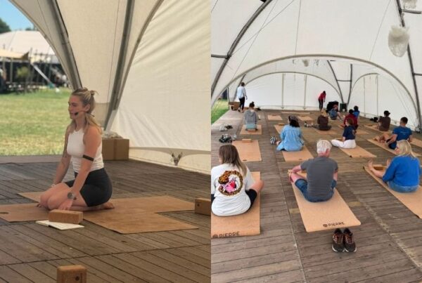 Morning yoga class at The Hive Resort Rock Werchter with festival-goers on Pierre Sports cork mats inside a large open tent overlooking the festival grounds